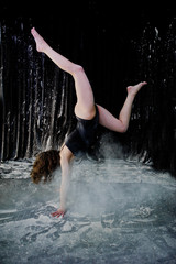 Girl dancer jumping and dancing in the white dust with flour on © AS Photo Family