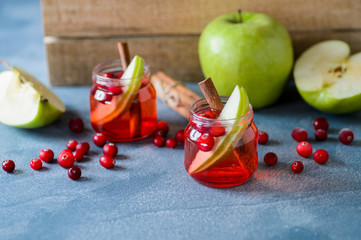 Cranberry drink with apples in glass cups.