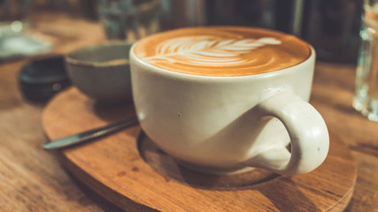 Tasty coffee latte art in vintage style.