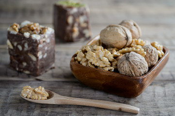 walnuts and nut halva on a rustic wooden surface.