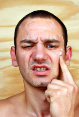 Obraz premium The young man shows his aching infected skin