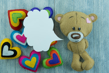 Valentines Day postcard. Teddy Bear and colourful hearts