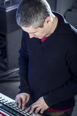 Young man in the process of offset printing and color correction