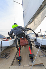disabled man with wheelchair on sailing boat