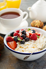 Rice pudding with fresh berries and coconut for breakfast