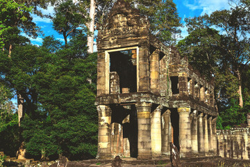 Naklejka premium Tower, huge trees and galleries in Preah Khan Temple