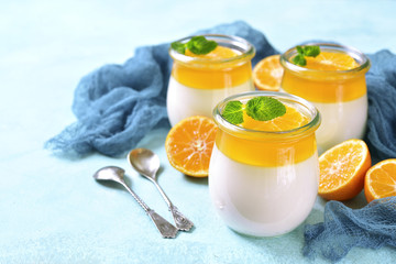 Panna cotta with orange jelly in a vintage jar,traditional itali