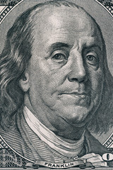 Vertical portrait of Benjamin Franklin's face on the US 100 dollar bill. Macro shot