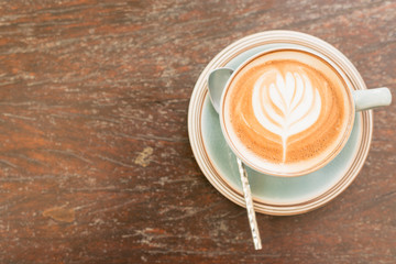 Coffee cup top view on wooden table background.
