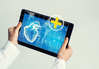 Close of female doctor hands working with tablet pc computer