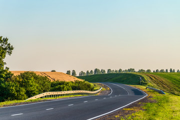 Turn countryside asphalt road with marking and guard rails. Belgorod region, Russia.
