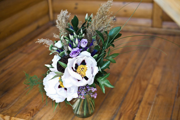 Beautiful bouquet on a wooden table decorated tree bark
