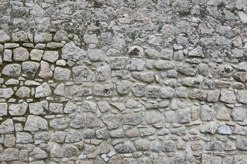 Old grey stone granite wall background texture