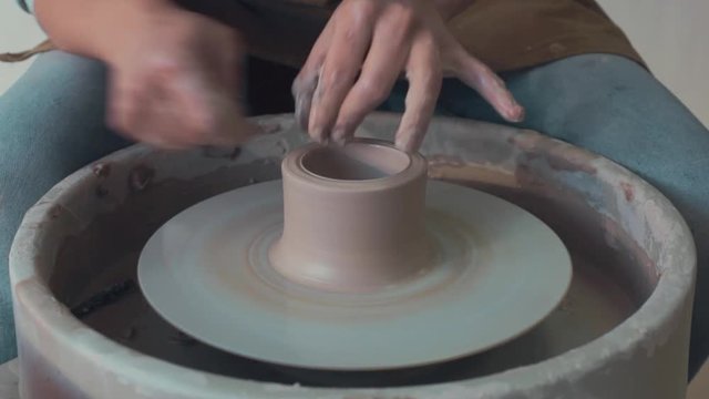 Potter Works On His Craft On A Spinning Pottery Wheel