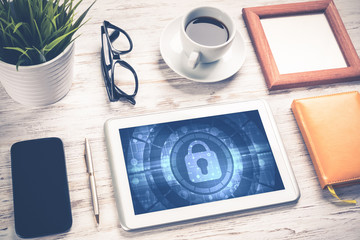 Web security and technology concept with tablet pc on wooden tab