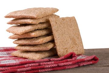 stack of crisp bread on a wooden table isolated  white background