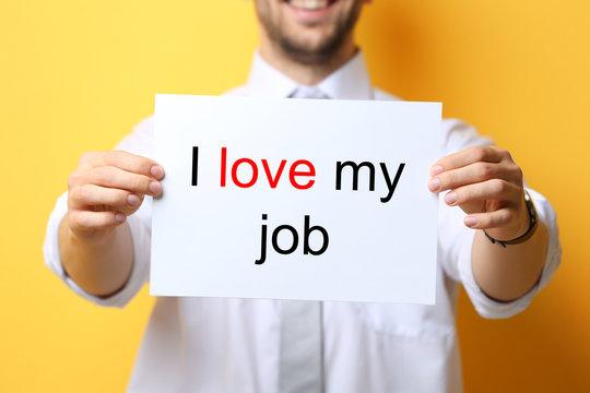 Man holding paper with text I LOVE MY JOB on color background