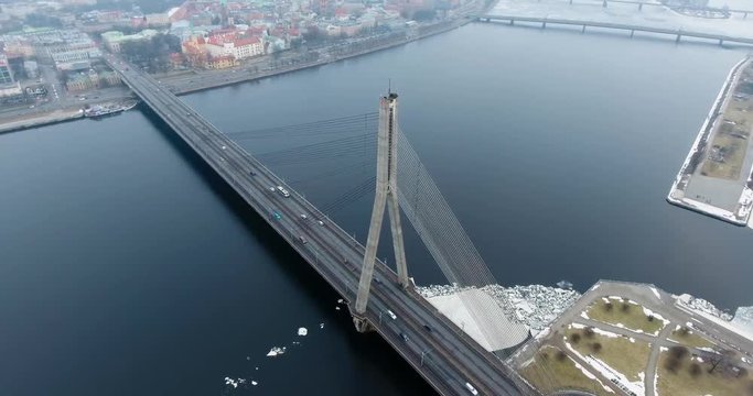 4K Aerial winter view of cable-stayed bridge over Daugava river in Riga Latvia. Vansu Bridge.