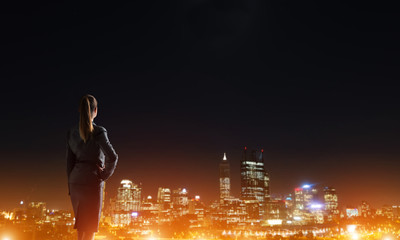 Woman looking at night city