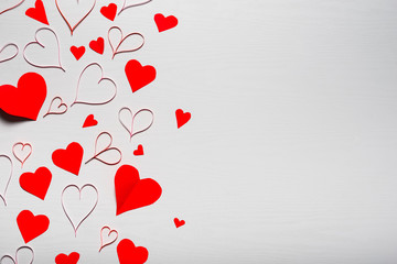 Wooden white background with red hearts. The concept of Valentin