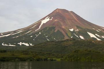 Fototapeta premium Picturesque summer volcanic landscape of Kamchatka Peninsula: view of active Ilyinsky Volcano (Ilyinskaya Sopka). Eurasia, Russia, Far East, Kurile lake, South Kamchatka Sanctuary