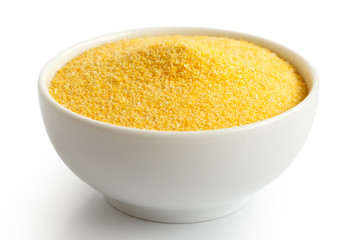 Cornmeal polenta in white ceramic bowl isolated on white.