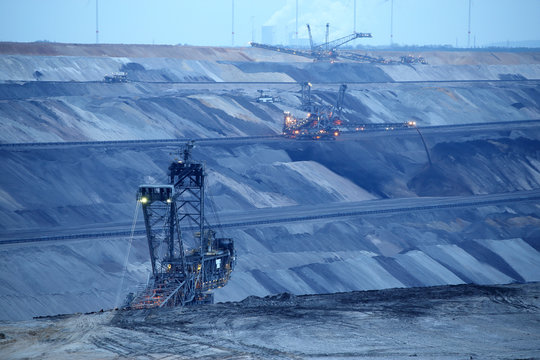 Large bucket wheel excavator and power plant in a lignite (brown-coal) mine after sunset, Germany
