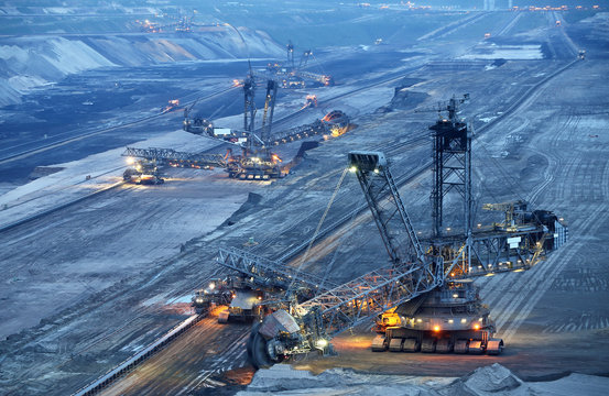 Large bucket wheel excavators in a lignite (brown-coal) mine after sunset, Germany
