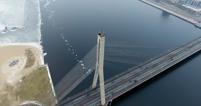 4K Aerial winter view of cable-stayed bridge over Daugava river in Riga Latvia. Vansu Bridge.