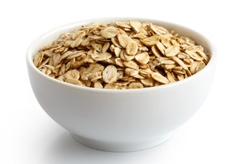 Dry porridge oats in white ceramic bowl isolated on white.