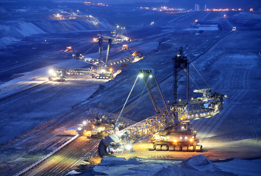 Large bucket wheel excavators in a lignite (brown-coal) mine after sunset, Germany