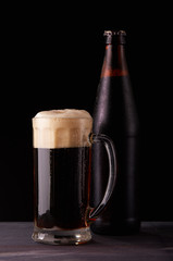 Dark beer. Bottle and mug.