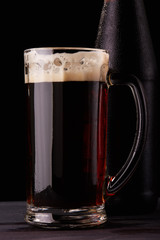 Dark beer. Bottle and mug.