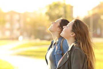 Two girls breathing fresh air in a park