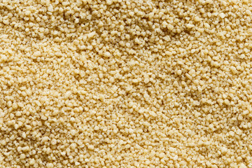 Background of dry couscous from above.