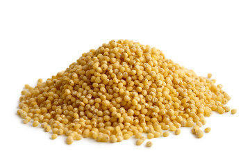 Heap of dry millet isolated on white.