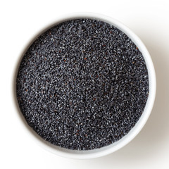 Dry poppy seeds in white ceramic bowl isolated on white.