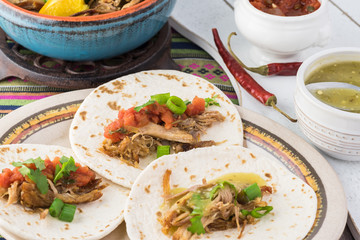 Mexican food. Slow cooked pork carnitas with salsa verde