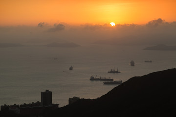Naklejka premium Ocean, islands, ships, coastline and sunset in Hong Kong, China, viewed from the Victoria Peak.