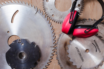 Circular saws and protective headphone on the table background. Top view