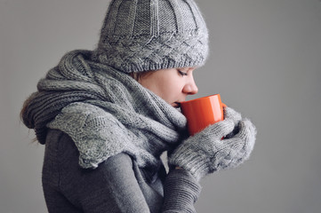 Woman warming up with a cup