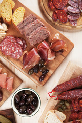 Charcuterie board with cured meat and olives