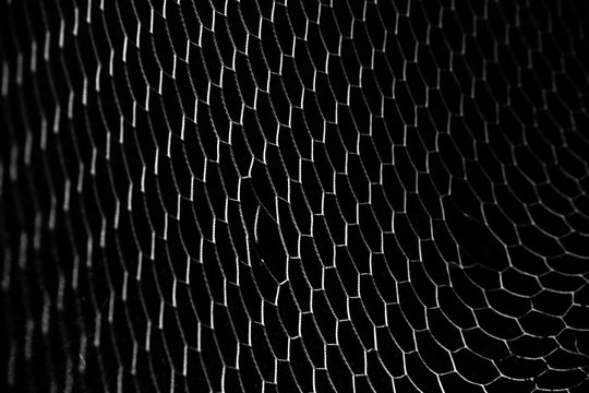 soccer ball in goal net isolated on black background
