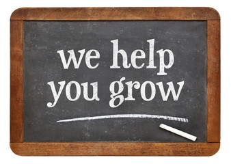 Obraz premium we help you grow blackboard sign