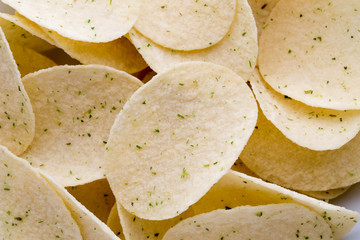 Close up potato chips on wood top view background.