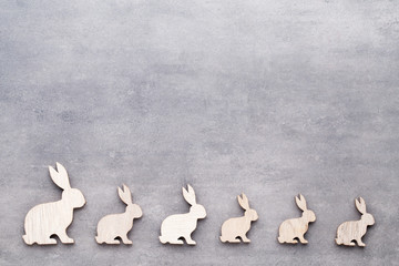 Handmade wood easter rabbits on wooden background.