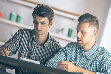 Attractive men doing paperwork