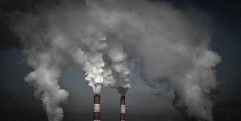 Smoking industrial chimneys in dark clouds. Concept for environmental protection. Ecology problems - 136103472