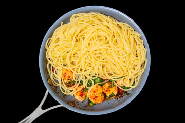 Spaghetti, prawns, fried in a skillet. Insulated
