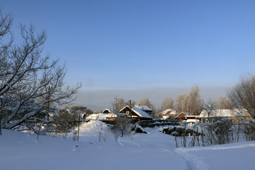 Village in a winter day and snow